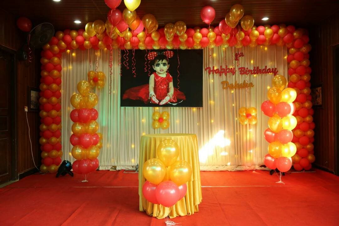 Birthday party with red and gold balloon décor by Red Q Events