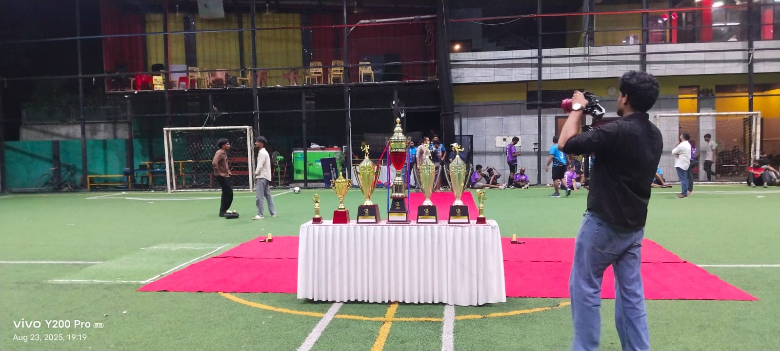 Trophy presentation table on turf at a corporate tournament by Red Q Events
