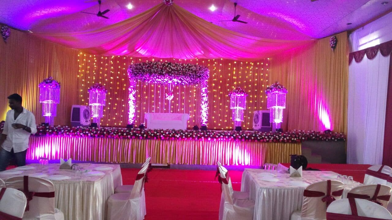 Pink and gold themed wedding stage with fairy lights in Kerala